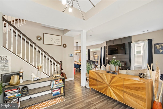 2205 Elsinore Ave, Baltimore, MD 21216 - living room featuring wood finished floors, stairway, and baseboards