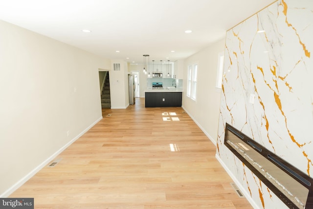 5315 Kenilworth Ave, Baltimore, MD 21212 - unfurnished living room with recessed lighting, visible vents, light wood-style floors, and stairs