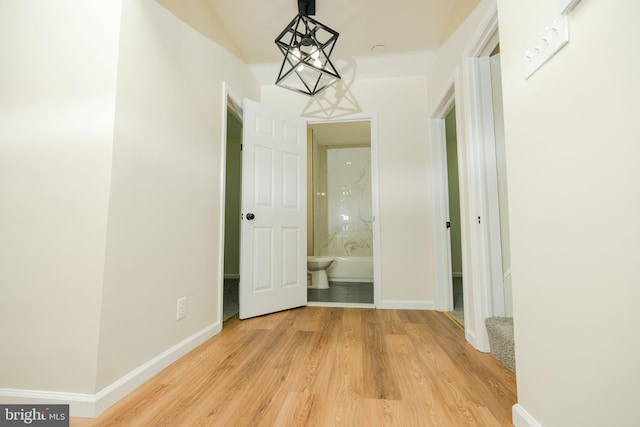 5315 Kenilworth Ave, Baltimore, MD 21212 - hall with baseboards, an inviting chandelier, and light wood-style floors