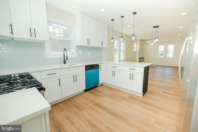 5315 Kenilworth Ave, Baltimore, MD 21212 - kitchen with dishwasher, a sink, freestanding refrigerator, light wood-type flooring, and a peninsula