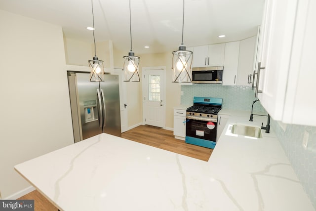 5315 Kenilworth Ave, Baltimore, MD 21212 - kitchen featuring tasteful backsplash, a sink, light wood finished floors, appliances with stainless steel finishes, and light stone countertops