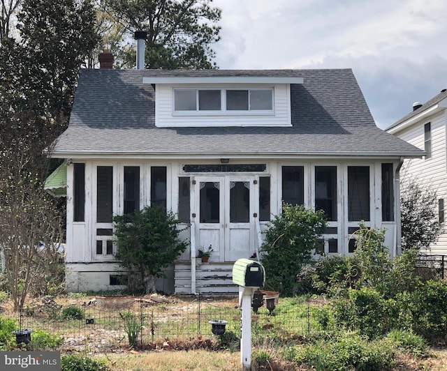 bungalow-style house featuring a shingled roof and entry steps