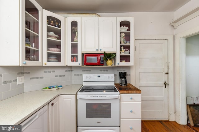 kitchen with white cabinetry, open shelves, white appliances, decorative backsplash, and glass insert cabinets