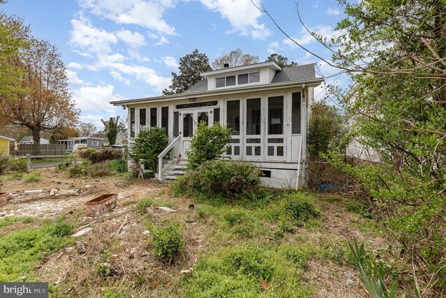 back of house with a sunroom and crawl space