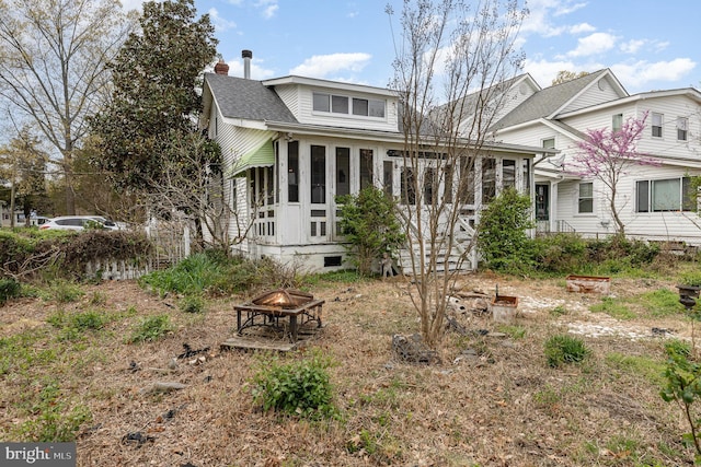 rear view of house with a chimney, a fire pit, crawl space, and roof with shingles