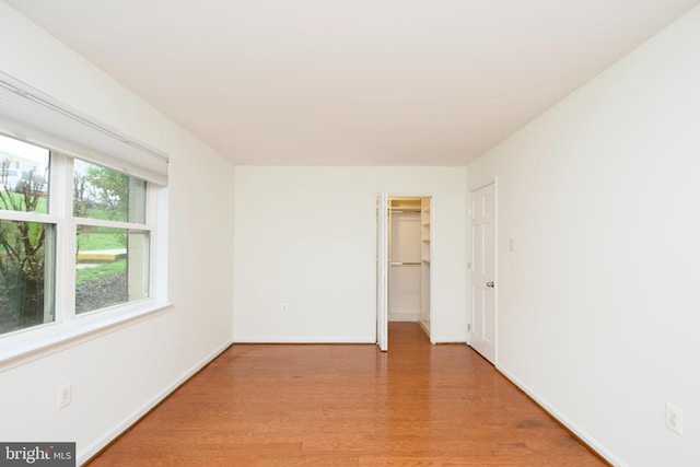 spare room with light wood-style flooring and baseboards