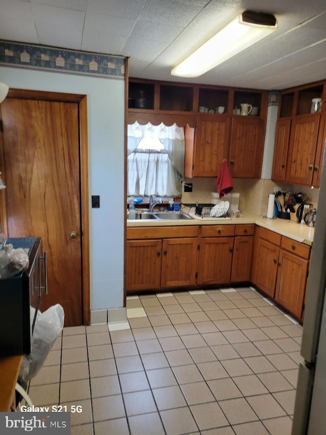 325 N Seton Ave, Emmitsburg, MD 21727 - kitchen featuring a sink, brown cabinetry, and light countertops