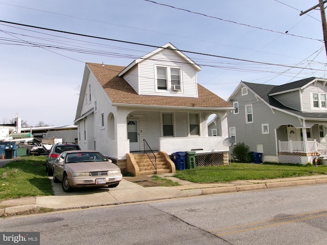 4204 Kenwood Ave, Baltimore, MD 21206 - view of front of home with a shingled roof, a porch, and stucco siding