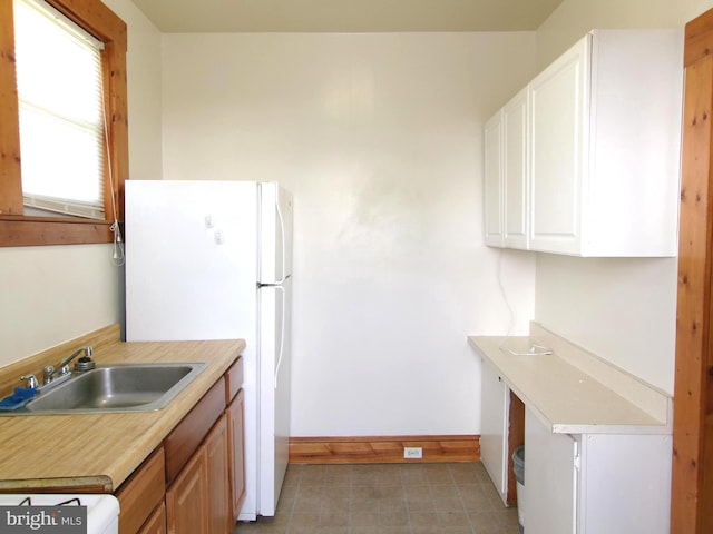 4204 Kenwood Ave, Baltimore, MD 21206 - kitchen with light countertops, baseboards, a sink, stove, and freestanding refrigerator
