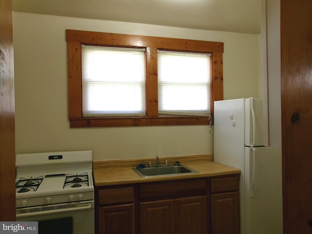 4204 Kenwood Ave, Baltimore, MD 21206 - kitchen with white appliances, light countertops, and a sink