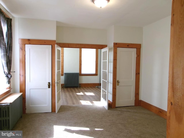 4204 Kenwood Ave, Baltimore, MD 21206 - carpeted empty room with radiator heating unit and baseboards