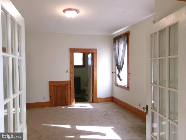 4204 Kenwood Ave, Baltimore, MD 21206 - carpeted empty room featuring baseboards and french doors