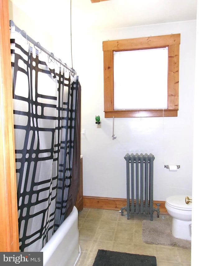 4204 Kenwood Ave, Baltimore, MD 21206 - bathroom featuring toilet, shower / bath combo with shower curtain, radiator, and baseboards