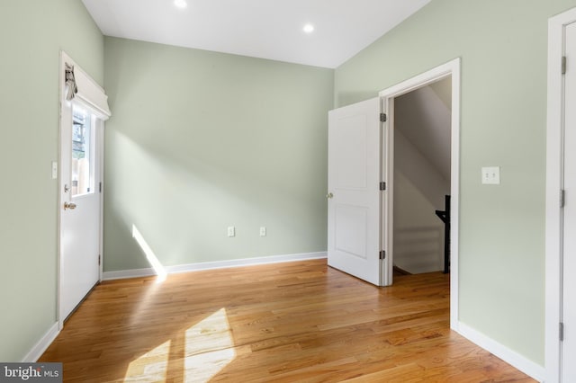 empty room with baseboards, light wood-style floors, and recessed lighting