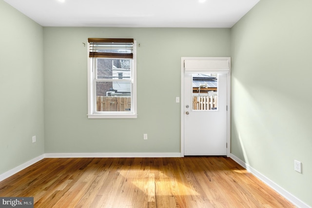 unfurnished room featuring baseboards and wood finished floors