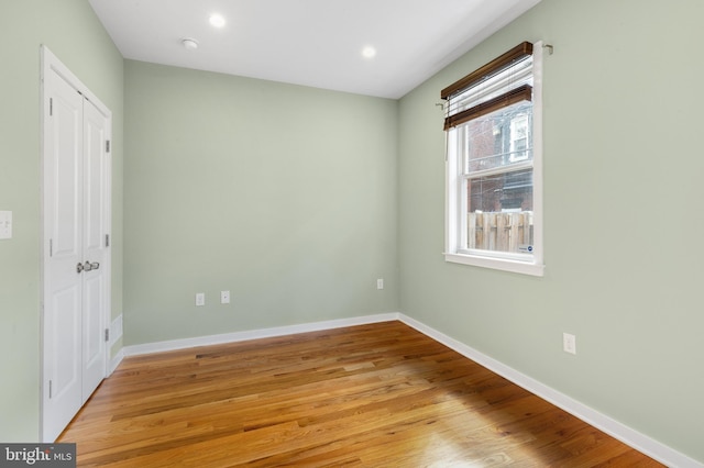 unfurnished bedroom featuring light wood finished floors, baseboards, and recessed lighting