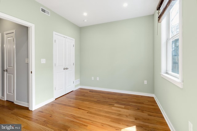 unfurnished bedroom with recessed lighting, baseboards, light wood finished floors, and visible vents