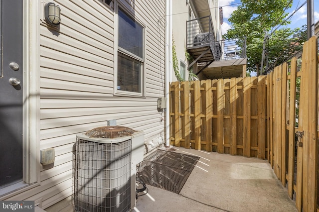exterior space featuring cooling unit and fence