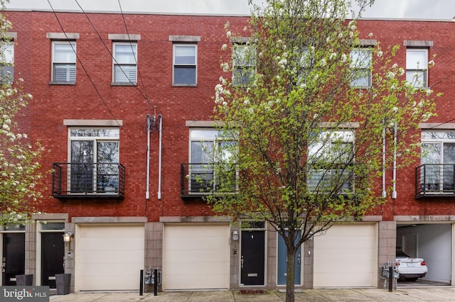 view of front of property featuring an attached garage and brick siding