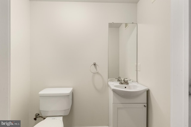 bathroom with toilet and vanity