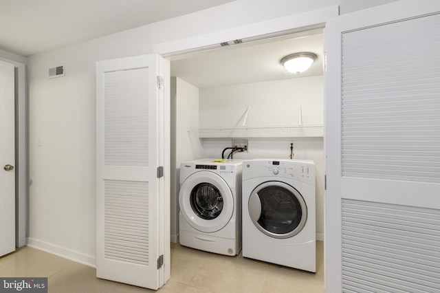 laundry area featuring light tile patterned floors, visible vents, laundry area, and washer and dryer