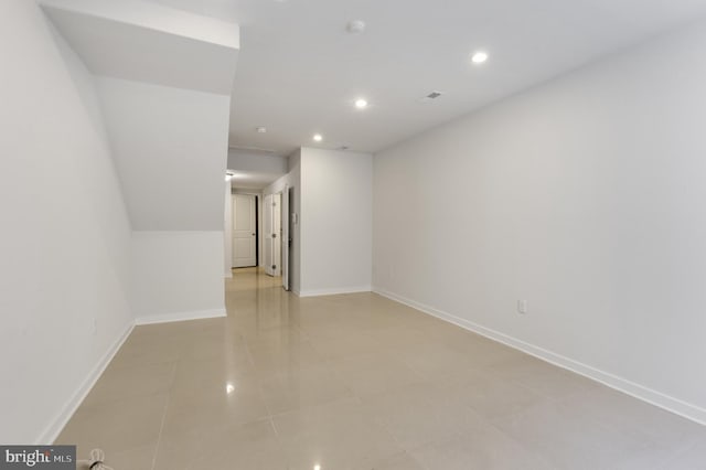 spare room with baseboards, recessed lighting, and light tile patterned floors