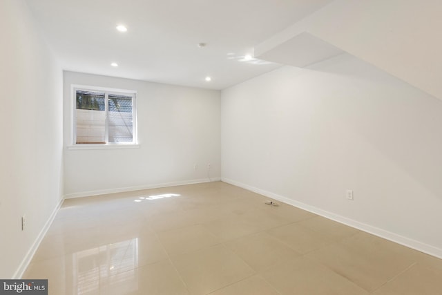 unfurnished room with baseboards, recessed lighting, and light tile patterned floors