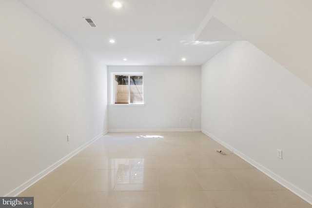 unfurnished room featuring light tile patterned flooring, visible vents, baseboards, and recessed lighting