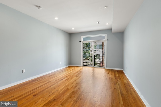 unfurnished room with baseboards, recessed lighting, and light wood finished floors