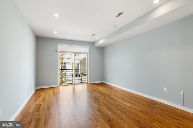 empty room with baseboards, visible vents, light wood-style floors, and recessed lighting