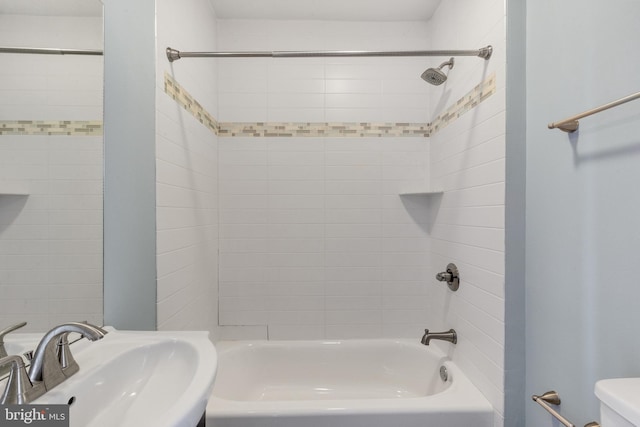 bathroom with toilet, a sink, and bathing tub / shower combination