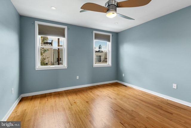 unfurnished room with baseboards and plenty of natural light