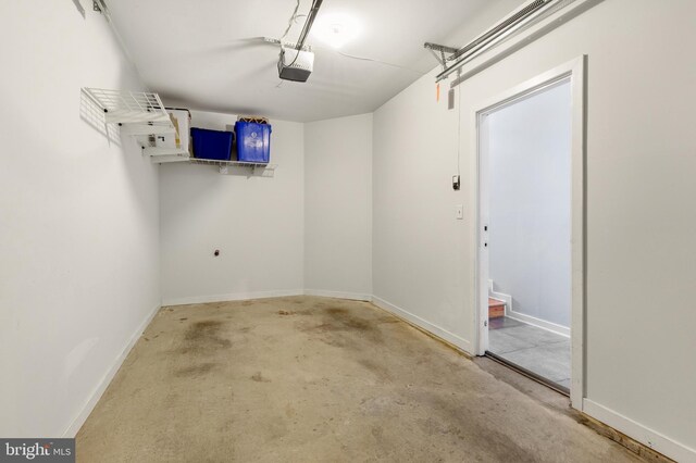 garage featuring baseboards and a garage door opener