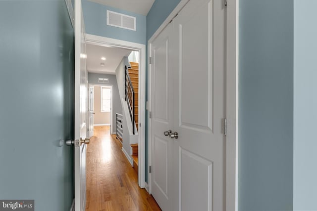 hall with light wood-type flooring and visible vents