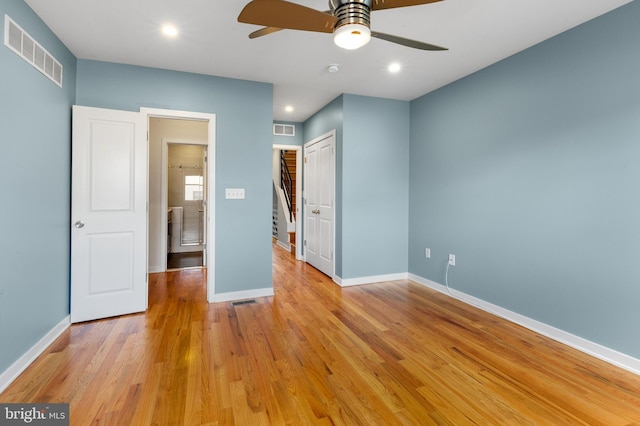 unfurnished bedroom with baseboards, visible vents, and light wood-style floors