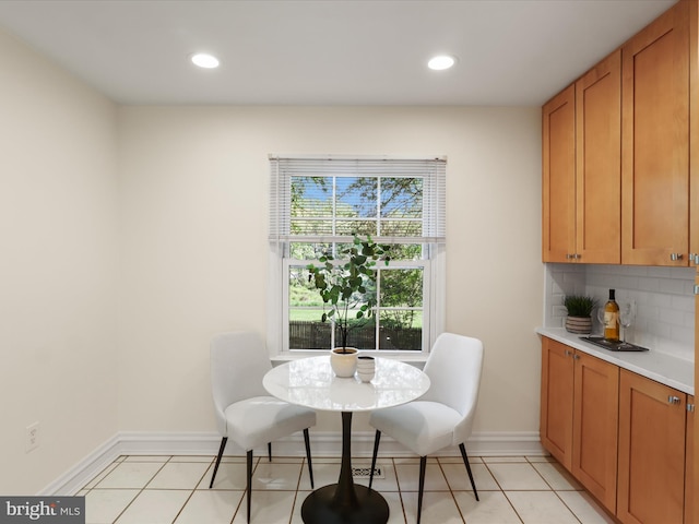 dining room with recessed lighting, baseboards, and light tile patterned floors