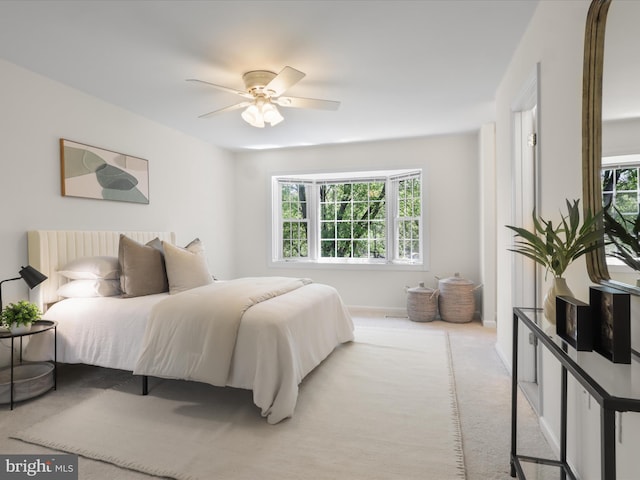 carpeted bedroom with baseboards and a ceiling fan