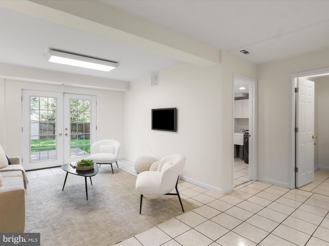 living room with baseboards, french doors, light tile patterned flooring, and visible vents