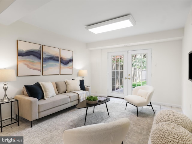 living area featuring light tile patterned flooring, baseboards, and french doors
