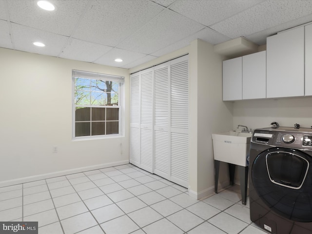 washroom with washer / dryer, light tile patterned flooring, baseboards, recessed lighting, and cabinet space
