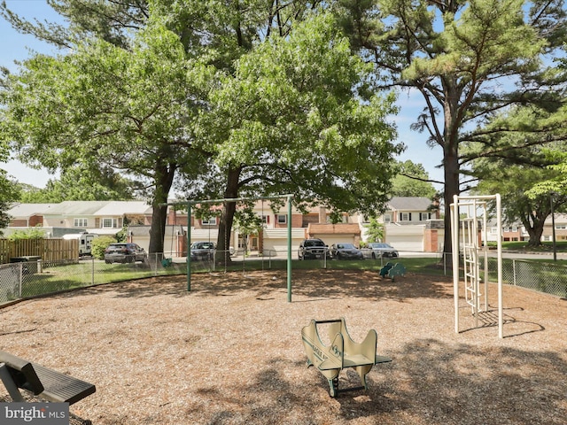 view of home's community with fence, playground community, and a residential view