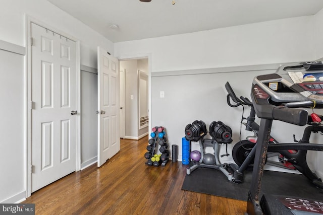 workout room with baseboards and wood finished floors