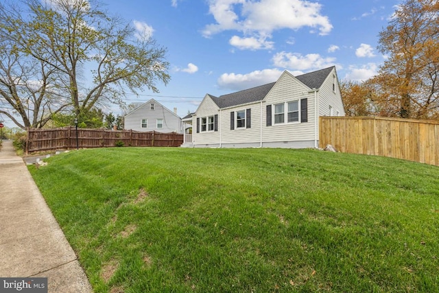view of property exterior featuring crawl space, fence, and a lawn