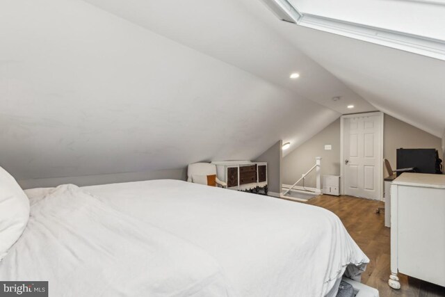 bedroom featuring wood finished floors, vaulted ceiling, and recessed lighting