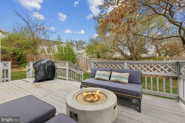 wooden deck featuring grilling area and a fenced backyard