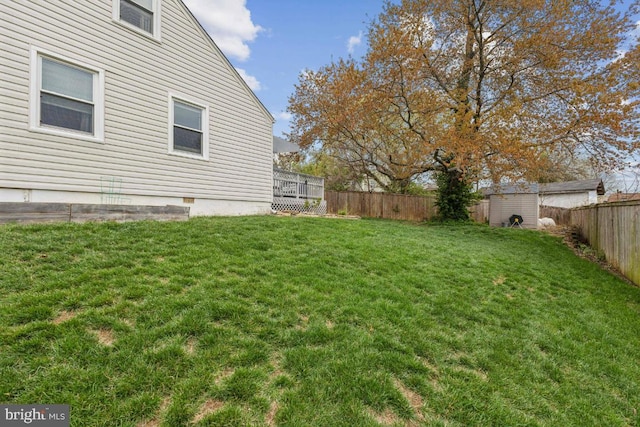 view of yard with a fenced backyard, an outdoor structure, and a shed