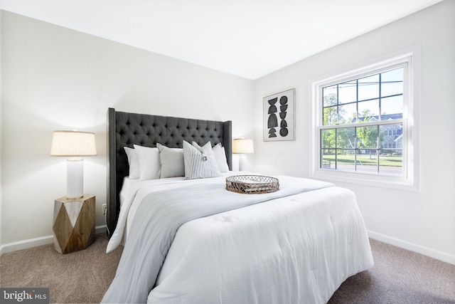 bedroom featuring carpet floors and baseboards