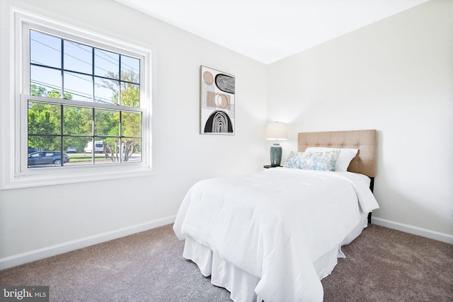 carpeted bedroom featuring baseboards