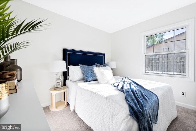 bedroom with baseboards and carpet flooring