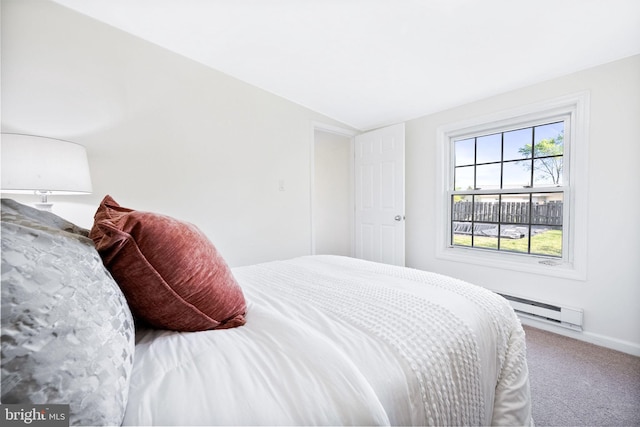 carpeted bedroom with baseboards, lofted ceiling, and baseboard heating